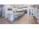 Spacious kitchen with island seating, stainless steel appliances, and built-in pantry at 7445 Mezzanine View Ave, Las Vegas, NV 89178