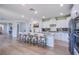 Open kitchen layout with center island, barstool seating, and stainless steel appliances at 7445 Mezzanine View Ave, Las Vegas, NV 89178