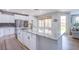 Large kitchen island with granite counters and open view to stainless appliances at 7445 Mezzanine View Ave, Las Vegas, NV 89178