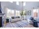 Bright living room with high ceilings, large windows, and stylish contemporary furniture at 7445 Mezzanine View Ave, Las Vegas, NV 89178