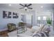 Spacious upstairs living room with comfortable seating, chic decor, and modern staircase at 7445 Mezzanine View Ave, Las Vegas, NV 89178