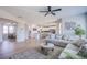 Open-concept living room with view into kitchen with island seating at 7445 Mezzanine View Ave, Las Vegas, NV 89178