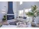 Living room with a tall fireplace, lots of windows, and modern decor at 7445 Mezzanine View Ave, Las Vegas, NV 89178