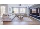 Bright living room featuring wood floors, large sofa, and modern decor at 7445 Mezzanine View Ave, Las Vegas, NV 89178