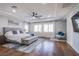 Main bedroom suite featuring hardwood floors, a plush bed, and lots of natural light at 7445 Mezzanine View Ave, Las Vegas, NV 89178