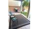 Comfortable covered patio with grill, chairs, and lush outdoor space at 7445 Mezzanine View Ave, Las Vegas, NV 89178