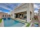 Inviting backyard with a refreshing pool, outdoor dining area, and sleek architectural design at 746 Horizon Canyon Dr, Henderson, NV 89052