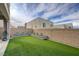 Well-maintained backyard with artificial turf, raised planters, and a privacy wall, perfect for relaxation at 746 Horizon Canyon Dr, Henderson, NV 89052