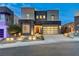 Modern two-story home featuring a stylish garage door, landscaped yard, and contemporary design at 746 Horizon Canyon Dr, Henderson, NV 89052