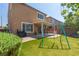 Wonderful backyard with brick landscaping, covered patio, and a swing set at 7652 Silver Baron Rd, Las Vegas, NV 89179