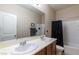 Bathroom with double sinks, large mirror, and bath tub with shower combo at 7652 Silver Baron Rd, Las Vegas, NV 89179