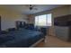Spacious bedroom with a ceiling fan and large window at 7652 Silver Baron Rd, Las Vegas, NV 89179