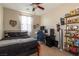 Comfortable bedroom with fan, window, and desk is perfect for work and rest at 7652 Silver Baron Rd, Las Vegas, NV 89179