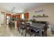 Dining area featuring a dark wood table, chairs, and view into the kitchen at 7652 Silver Baron Rd, Las Vegas, NV 89179
