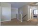 Upstairs hallway with carpet flooring leading to bedroom at 7652 Silver Baron Rd, Las Vegas, NV 89179