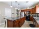 Kitchen with an island, stainless steel appliances, cabinets and granite countertops at 7652 Silver Baron Rd, Las Vegas, NV 89179
