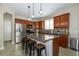 Kitchen boasts an island, stainless steel appliances, and granite countertops at 7652 Silver Baron Rd, Las Vegas, NV 89179