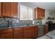 Kitchen featuring granite countertops, stainless steel appliances, and a mosaic backsplash at 7652 Silver Baron Rd, Las Vegas, NV 89179