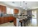 Kitchen featuring an island with granite countertops, pendant lighting, and wood cabinets at 7652 Silver Baron Rd, Las Vegas, NV 89179