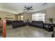 Spacious living area with tile flooring, a ceiling fan, and large windows at 7652 Silver Baron Rd, Las Vegas, NV 89179