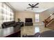 Cozy living area with tile flooring, a ceiling fan, and stairs to the second level at 7652 Silver Baron Rd, Las Vegas, NV 89179