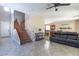 Open-concept living area showcasing tile floors, a staircase, and seamless flow into the kitchen at 7652 Silver Baron Rd, Las Vegas, NV 89179