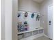Mud room with a built-in bench, storage baskets, and hooks for hanging items at 7652 Silver Baron Rd, Las Vegas, NV 89179