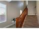Carpeted staircase with wooden railing and window, creating a bright and welcoming space at 7652 Silver Baron Rd, Las Vegas, NV 89179