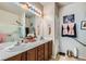 Bathroom boasts double sinks, great lighting, and a shower with glass door enclosure at 7717 Pine Warbler Way, North Las Vegas, NV 89084