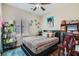 Bedroom features a comfy bed with a ceiling fan and lots of natural light from the window at 7717 Pine Warbler Way, North Las Vegas, NV 89084