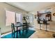 Open-concept dining area with stylish furnishings and a view into the kitchen with bar seating at 7717 Pine Warbler Way, North Las Vegas, NV 89084