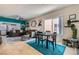 Open-concept dining area with stylish furnishings, a bright window, and seamless flow to the living spaces at 7717 Pine Warbler Way, North Las Vegas, NV 89084