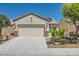 Charming single-story home featuring desert landscaping, a two-car garage, and a well-maintained front yard at 7717 Pine Warbler Way, North Las Vegas, NV 89084