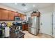 Functional kitchen featuring stainless steel appliances, dark granite countertops, and ample cabinet space at 7717 Pine Warbler Way, North Las Vegas, NV 89084