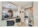 Open-concept kitchen with stainless steel appliances and a breakfast bar, seamlessly connected to the dining area at 7717 Pine Warbler Way, North Las Vegas, NV 89084