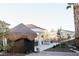 Backyard featuring a tiki hut, outdoor kitchen, and beautifully landscaped space at 7745 Radcliff St, Las Vegas, NV 89123