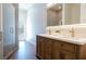 Bathroom with a double vanity, glass shower, and view to backyard pool at 7745 Radcliff St, Las Vegas, NV 89123