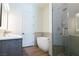 Bathroom featuring a modern tub, glass shower, and double vanity at 7745 Radcliff St, Las Vegas, NV 89123
