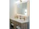 Modern bathroom features a light wood vanity with a quartz countertop, double sink, and an LED mirror at 7745 Radcliff St, Las Vegas, NV 89123
