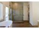 Primary bathroom featuring natural light, a free-standing tub, and a glass enclosed shower at 7745 Radcliff St, Las Vegas, NV 89123