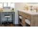 Elegant bathroom features a vanity with double sinks, stylish fixtures, and a makeup desk area with a decorative floral pattern at 7745 Radcliff St, Las Vegas, NV 89123