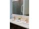 Bathroom vanity with double sinks, modern fixtures, and a backlit mirror at 7745 Radcliff St, Las Vegas, NV 89123