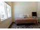Bedroom features a stylish area rug, and window with a view of the backyard at 7745 Radcliff St, Las Vegas, NV 89123