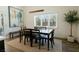 Charming dining area with natural light, minimalist decor, and view of the manicured backyard at 7745 Radcliff St, Las Vegas, NV 89123