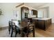 Bright dining area features a modern table set, and is adjacent to the kitchen island with stainless steel appliances at 7745 Radcliff St, Las Vegas, NV 89123