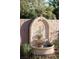 A close up of a decorative fountain in a landscaped back yard with paver patio at 7745 Radcliff St, Las Vegas, NV 89123
