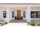 Inviting front entrance with a solid wood door and decorative planters at 7745 Radcliff St, Las Vegas, NV 89123