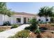 Charming single-story home featuring a tile roof, landscaped yard, and a welcoming front porch with classic column supports at 7745 Radcliff St, Las Vegas, NV 89123