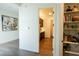 Bright hallway view with light wood flooring and decor that leads to the kitchen at 7745 Radcliff St, Las Vegas, NV 89123