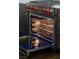 An open oven with stainless steel racks and a blue interior at 7745 Radcliff St, Las Vegas, NV 89123